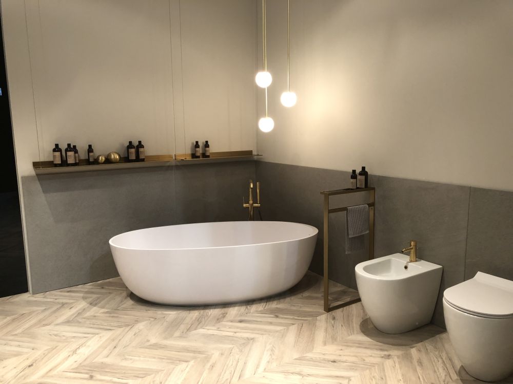 Bathroom with brass accents and dipped grey wall