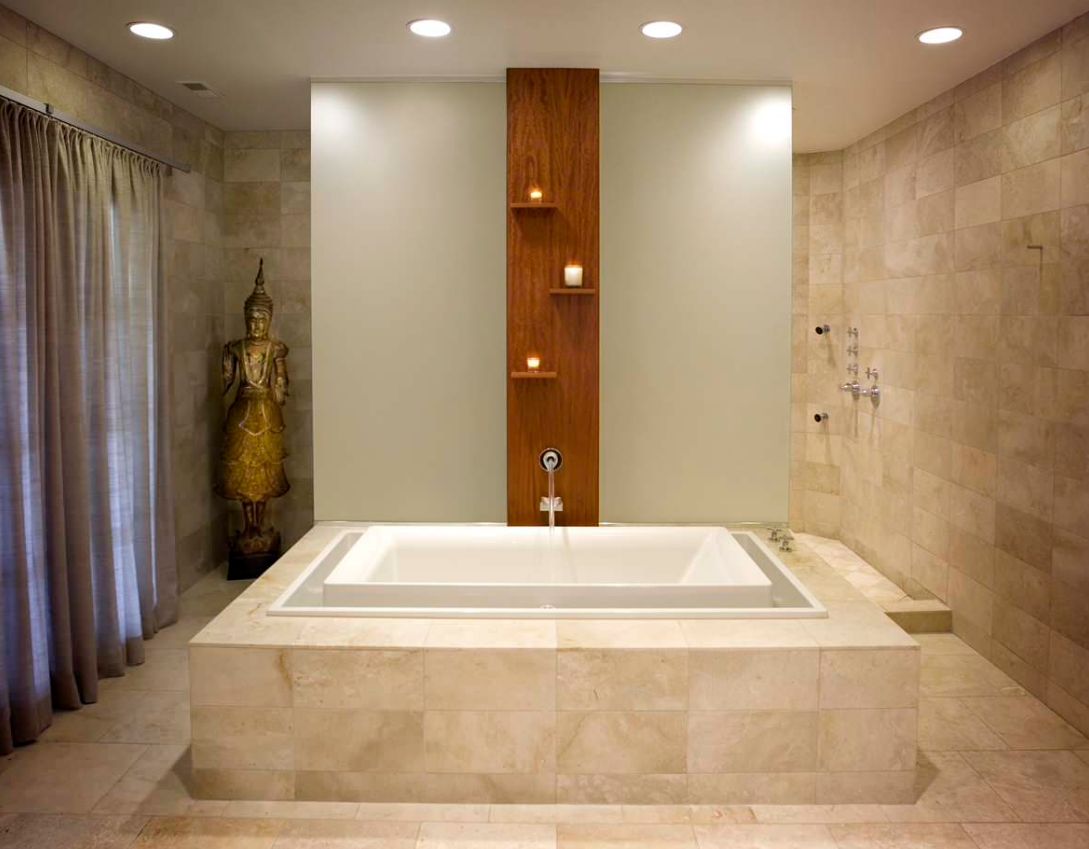 A tall metal Asian statue emphasizes the Zen feeling of this Chicago bathroom's design.