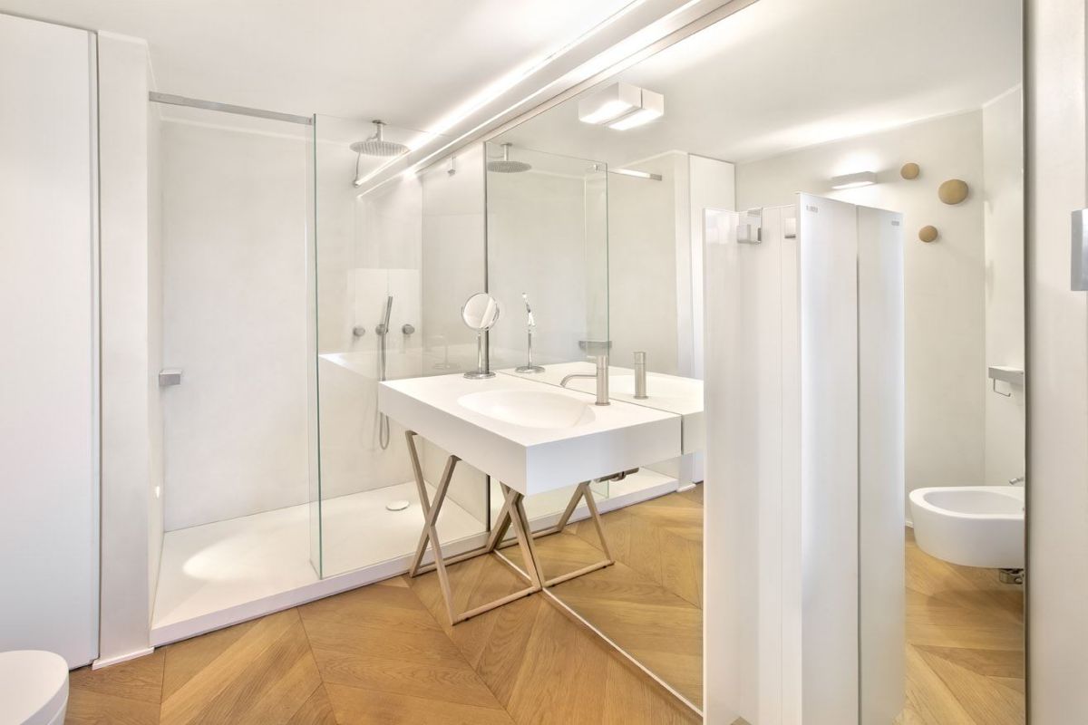 Bathroom with hardwood floors and large mirror