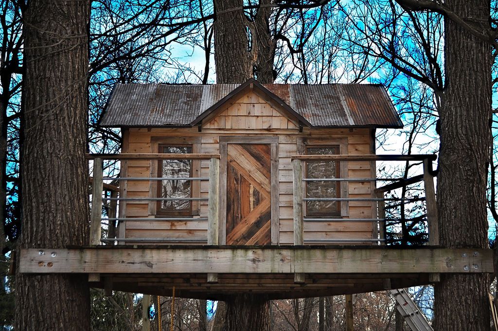 A large treehouse suspended between trees