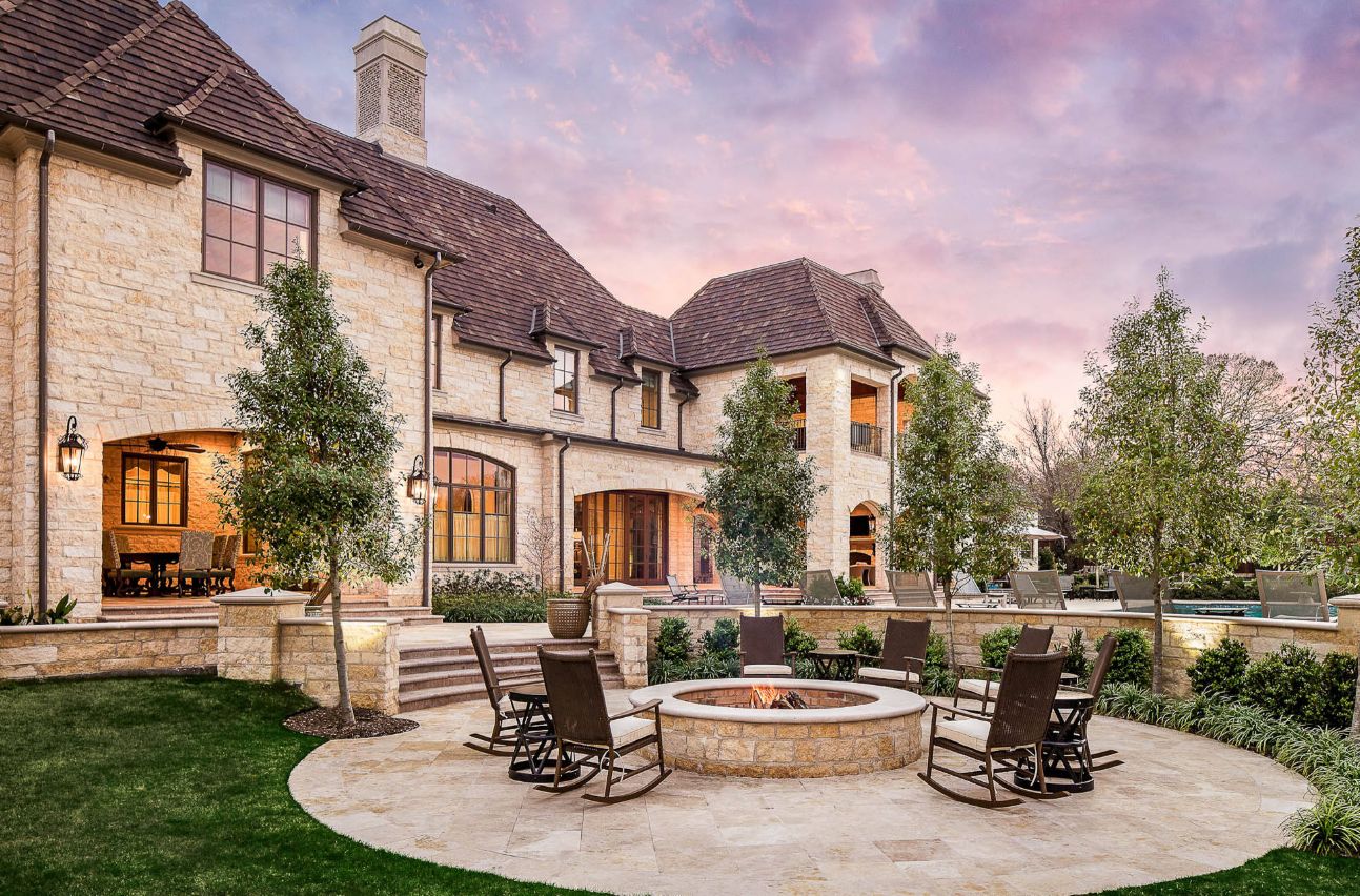 Beautiful conversation area with brick rock fire pit and rocking chairs