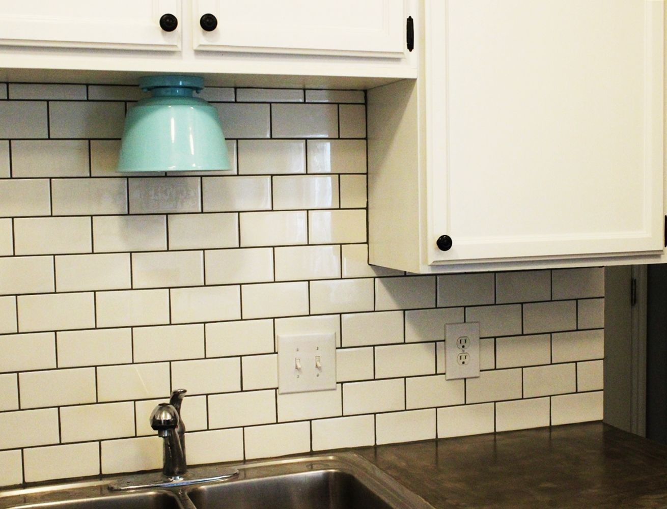 Beautiful kitchen backsplash with tiles and turquoise lighting fixture