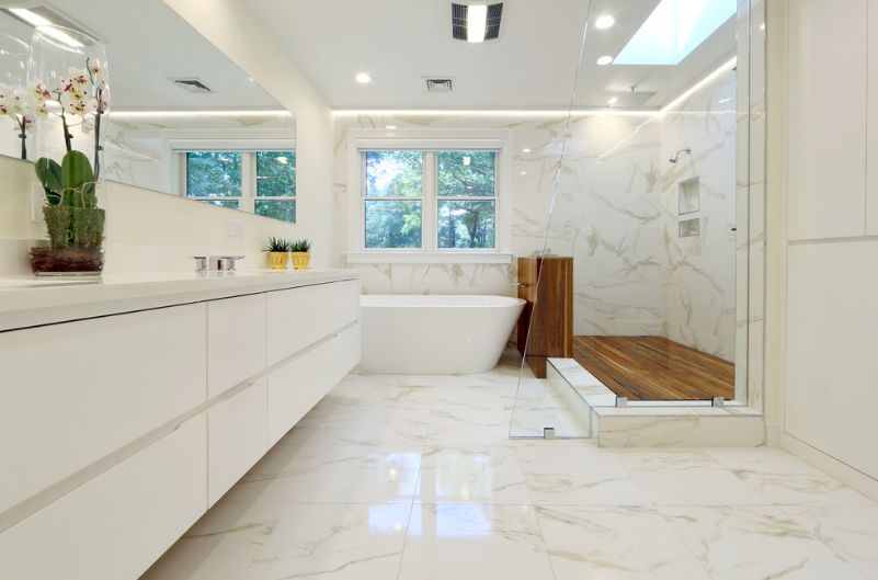 Beautiful white bathroom with marble and wood deck for shower