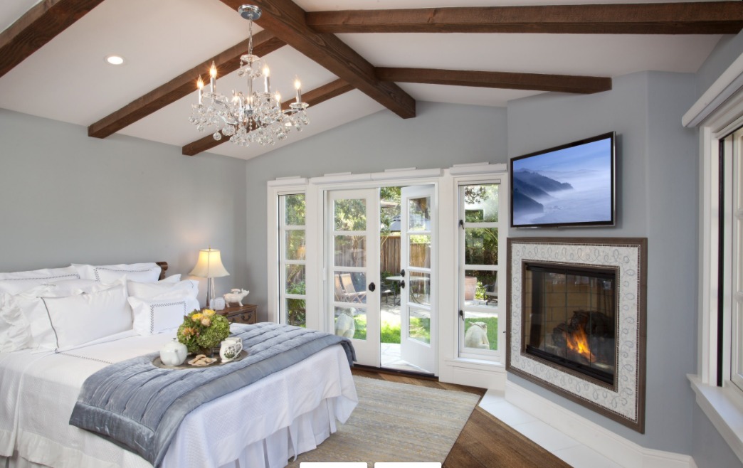 Bedroom fireplace with tv above