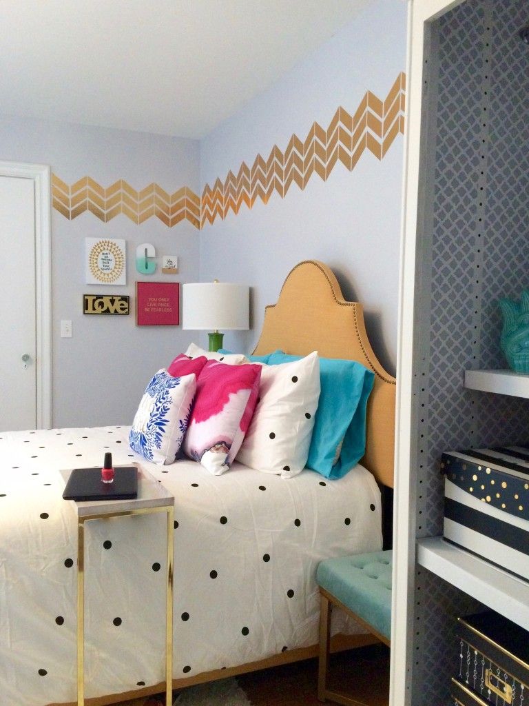 Bedroom with black and white polka dots bedding and gold furniture accents