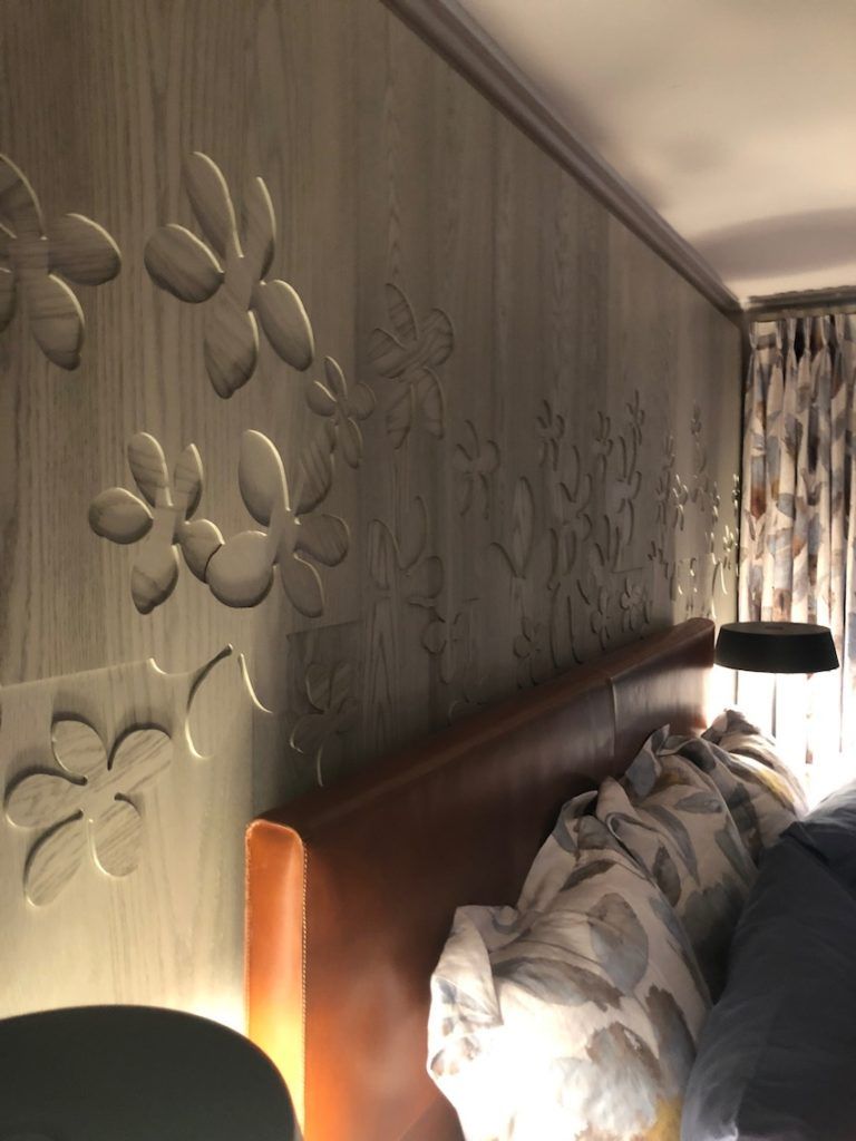The custom wood creation on the wall is eye-catching yet calm and soothing.