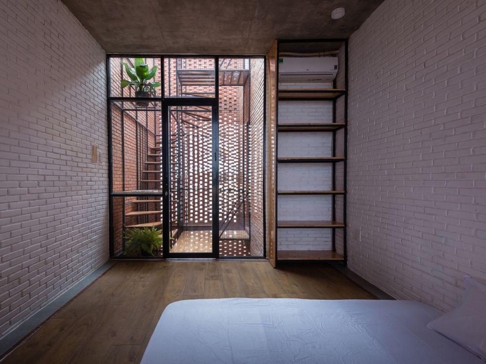 Bedroom with natural light from perforated facade