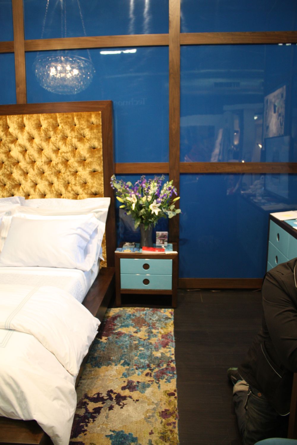 Bedroom with tufted velvet headboard and ombre carpet