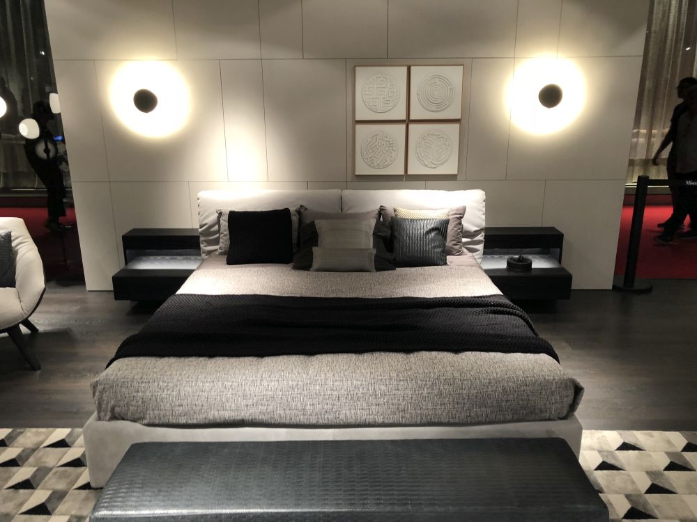 Bedroom with upholstered gray bed and headboard