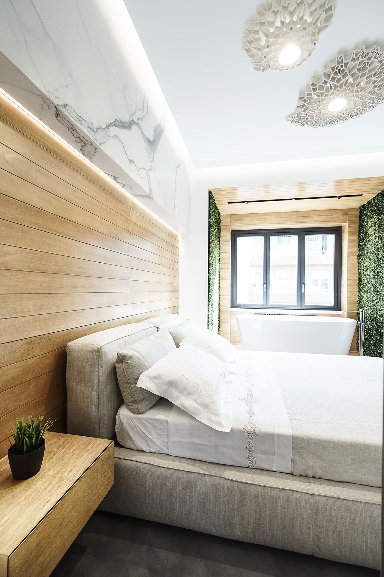 A padded headboard and bed frame add softness to the bedroom.