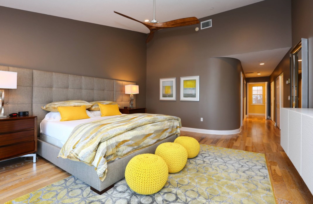 Bedroom with yellow poufs