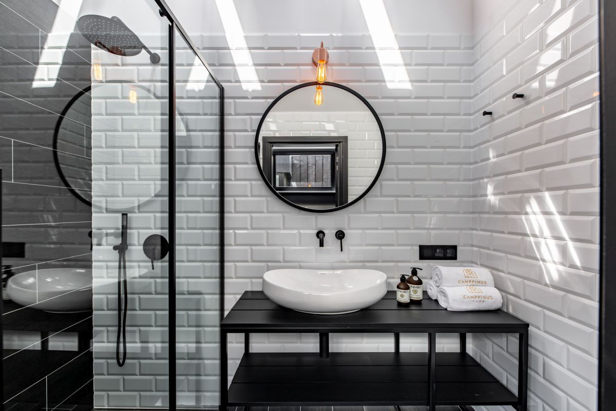 Black and white bathroom with framed showr and subway tiles