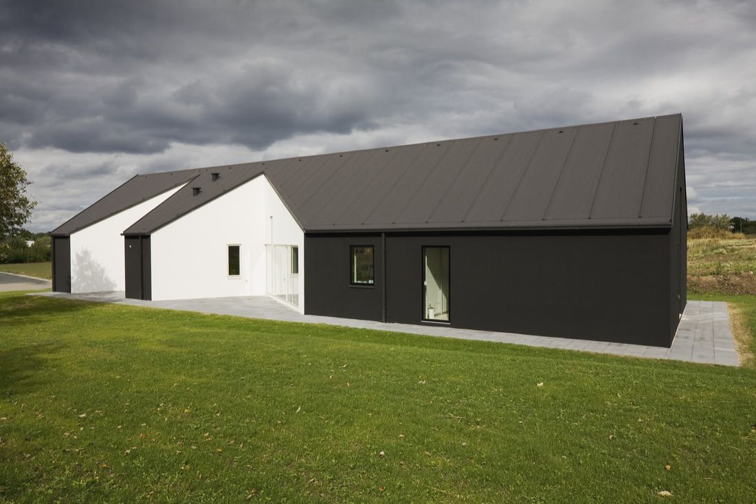 Sinus House Featuring a Black Roof