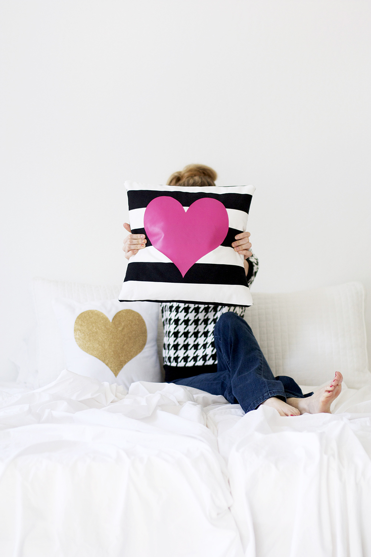 Black and white striped pillow with a pink heart