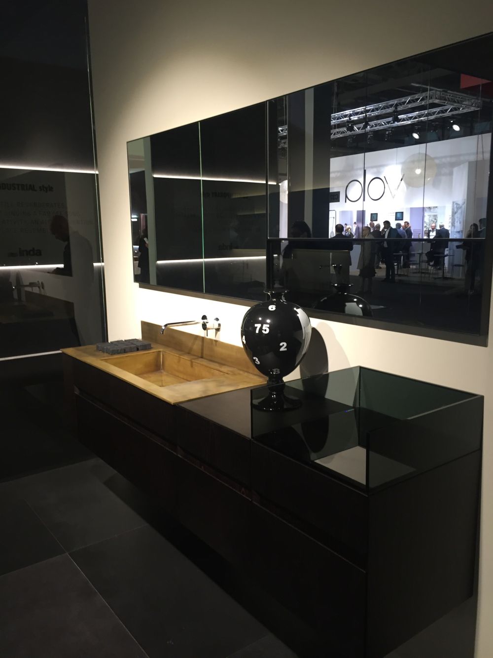 Black bathroom vanity with gold accents for wash basin and glass storage