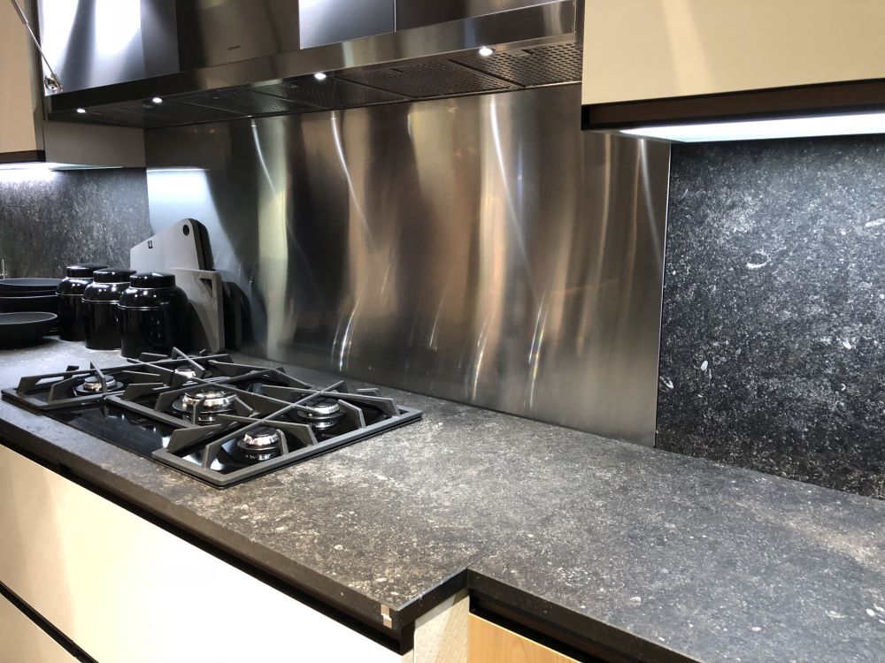 Black composit kitchen countertop and stainless steel backsplash