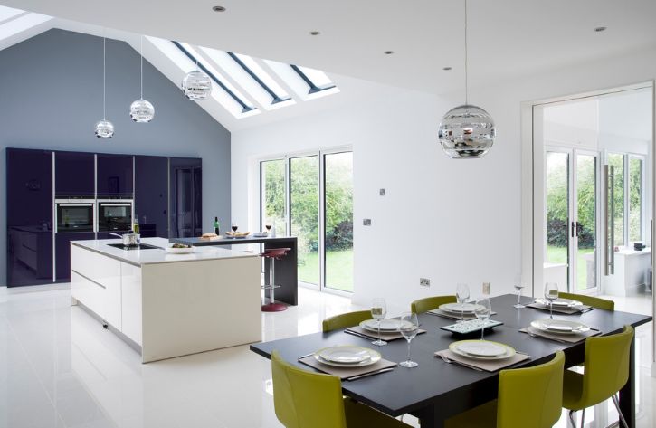 Black dining table with green chairs