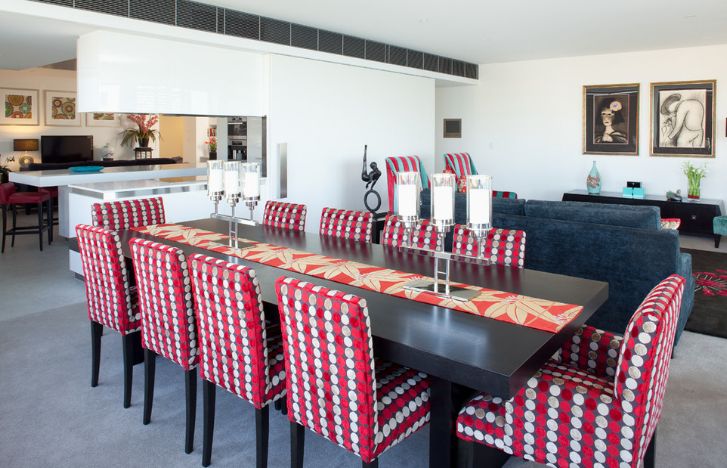 Black dining table with red armchairs