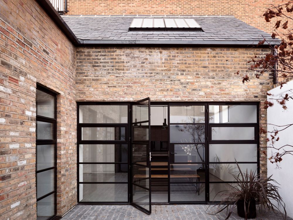 Black frames and brick Former warehouse into home by Paper House Project