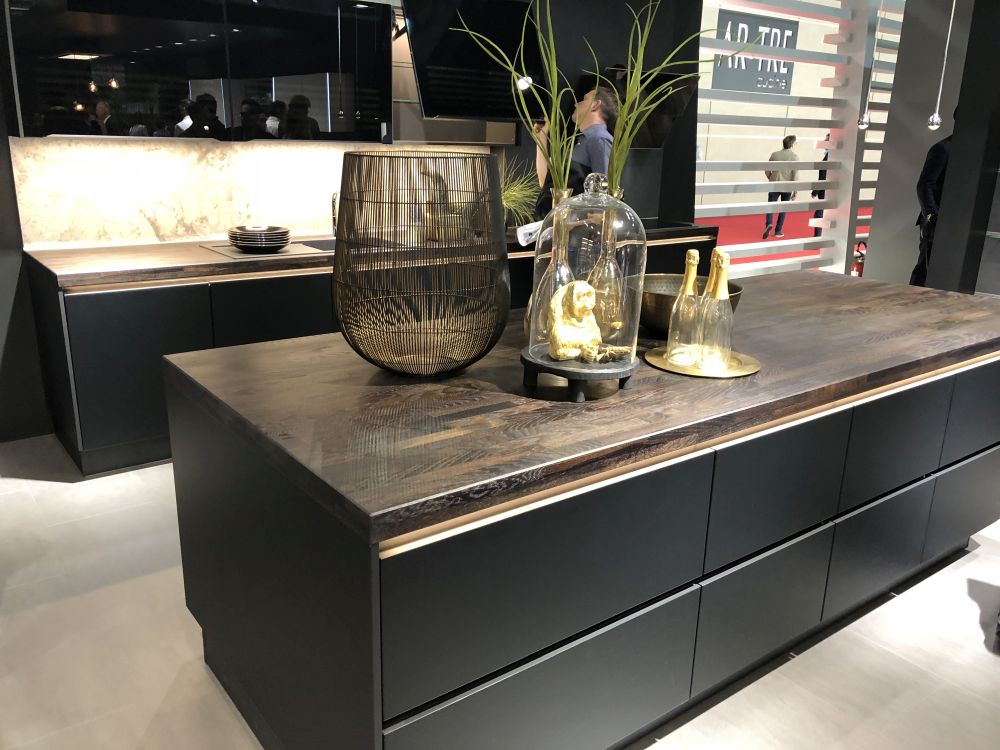 Black kitchen island cabinets and wood countertop