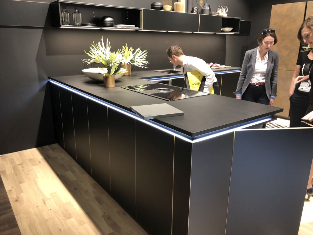 Black kitchen layout L shaped with white striped and LED lights