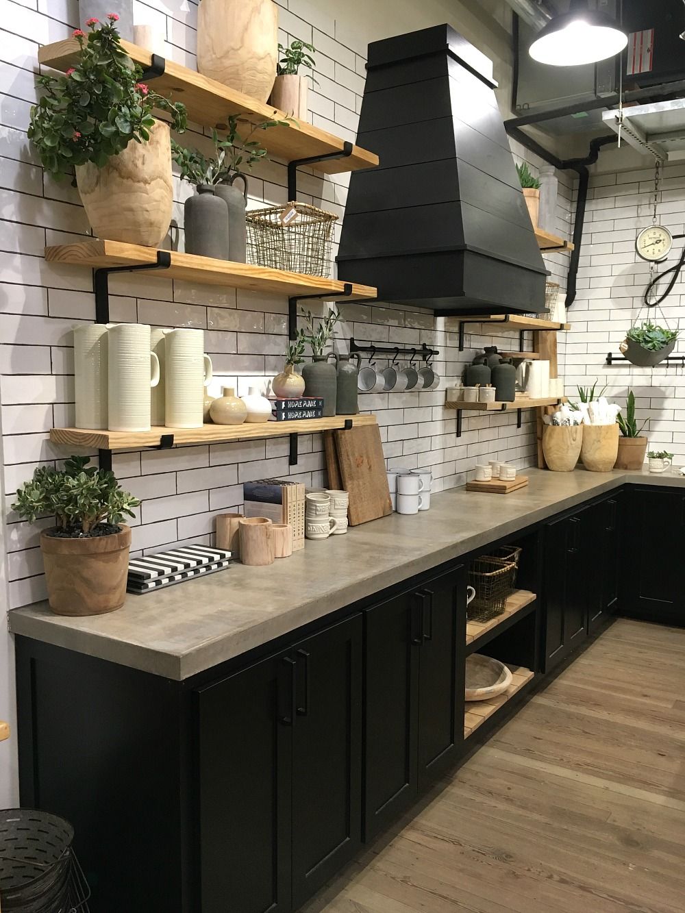 Black kitchen lower cabinets and concrete countertop