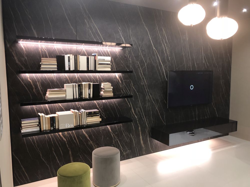 Black marble wall with floating shelves and Tv on the console