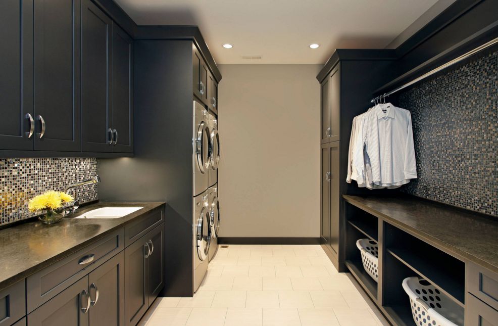 Black master laundry room with four stacked appliances
