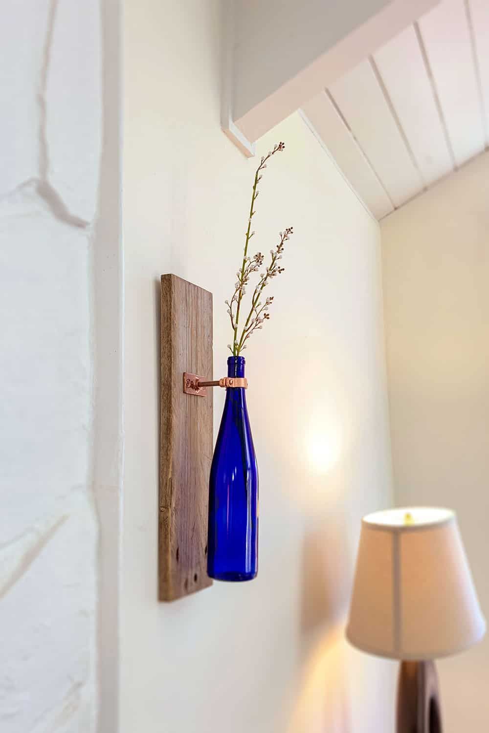 Blue accent bottle turned into a wall vase