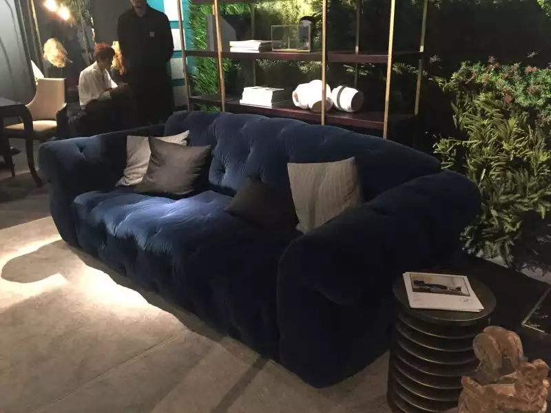 blue-tufted-sofa-with-throw-pillows