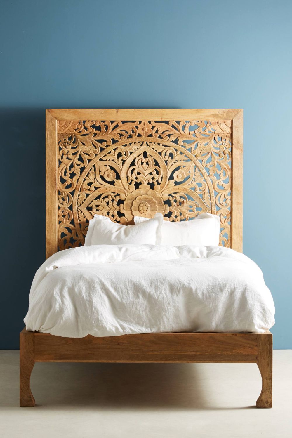 Boho bedroom with carved headboard