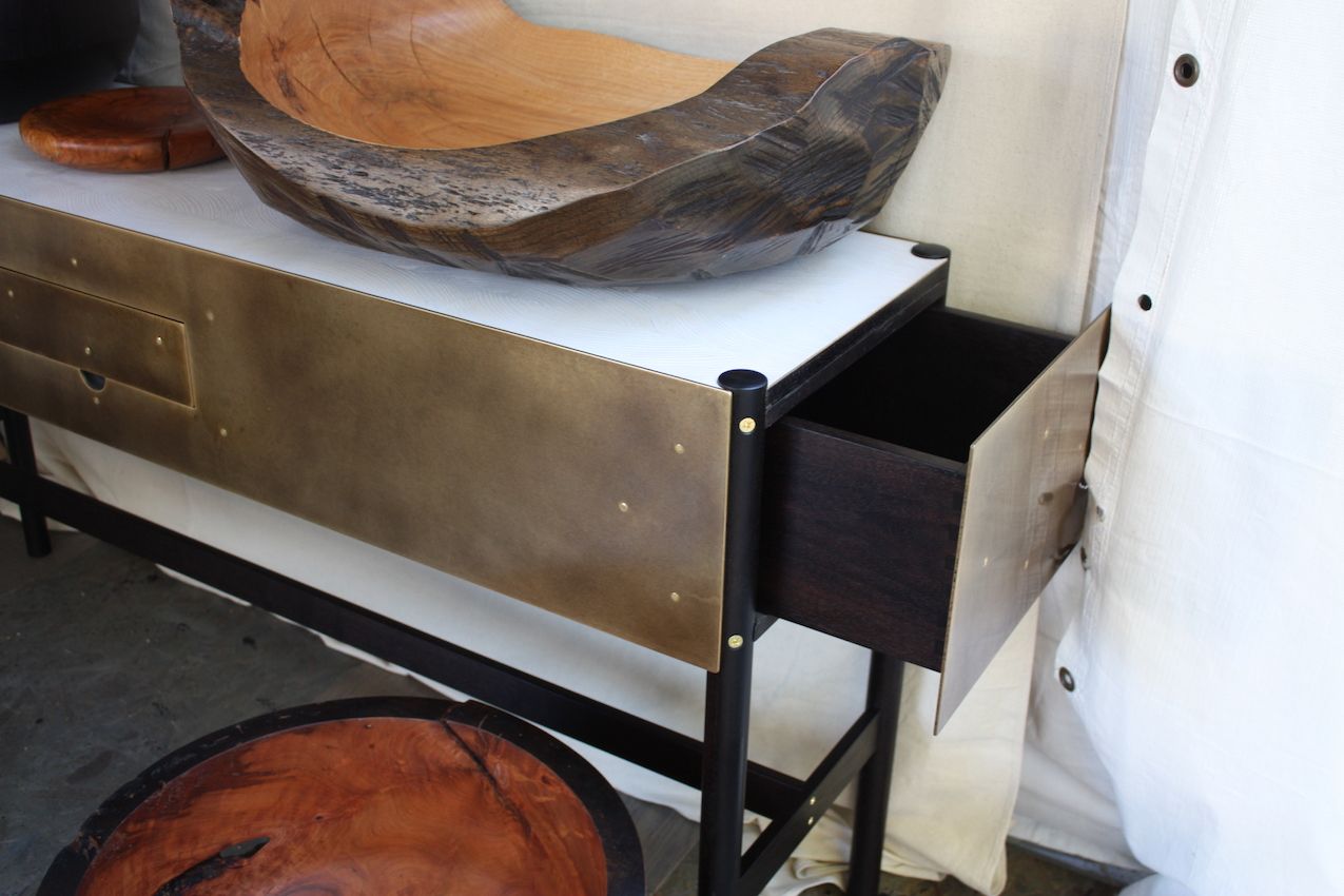 The brass Phillips console table opens from the end.