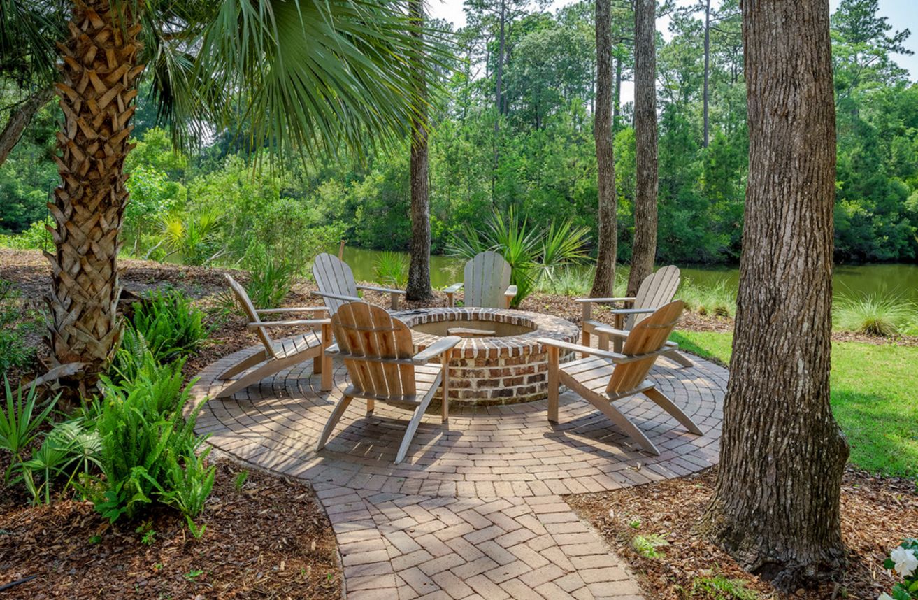 Brick fire pit for backyard with adirondack chairs