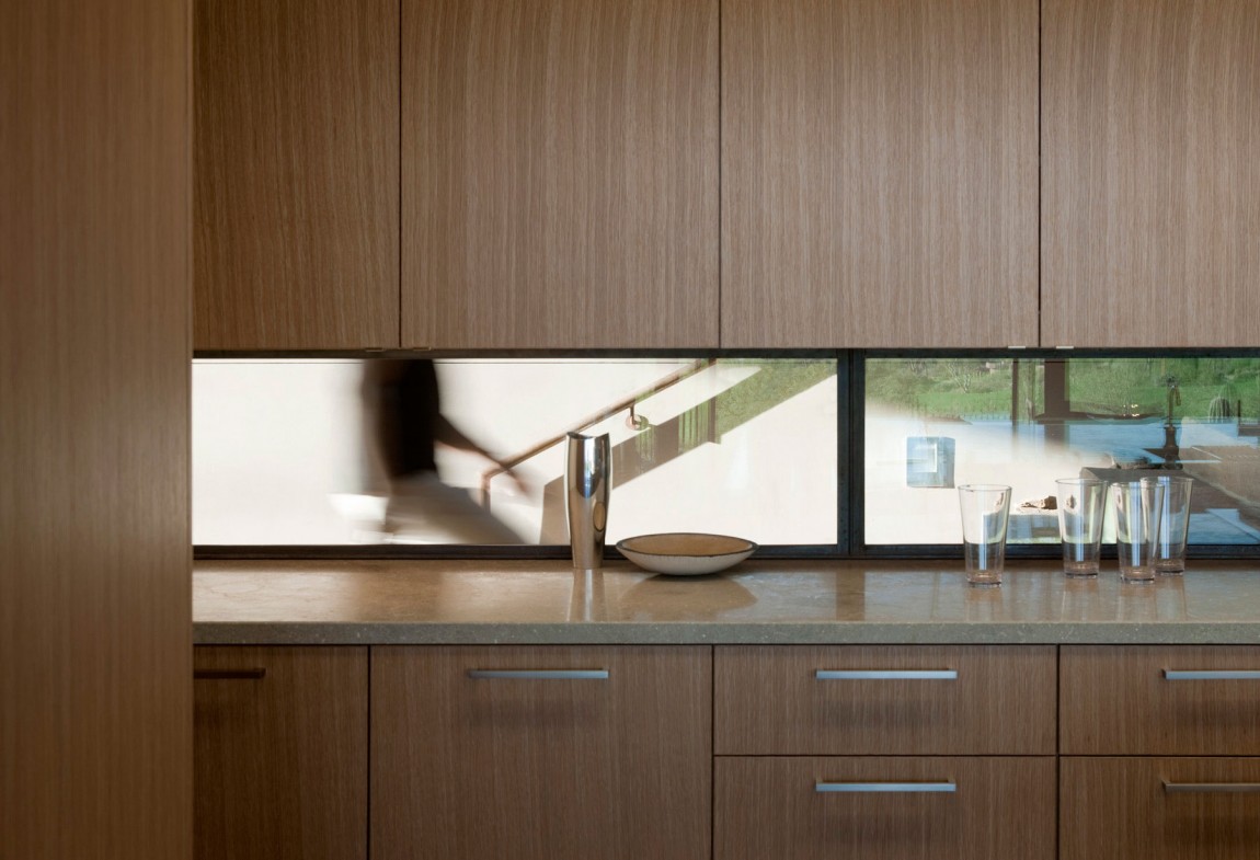 Brown Kitchen With Window above countertop