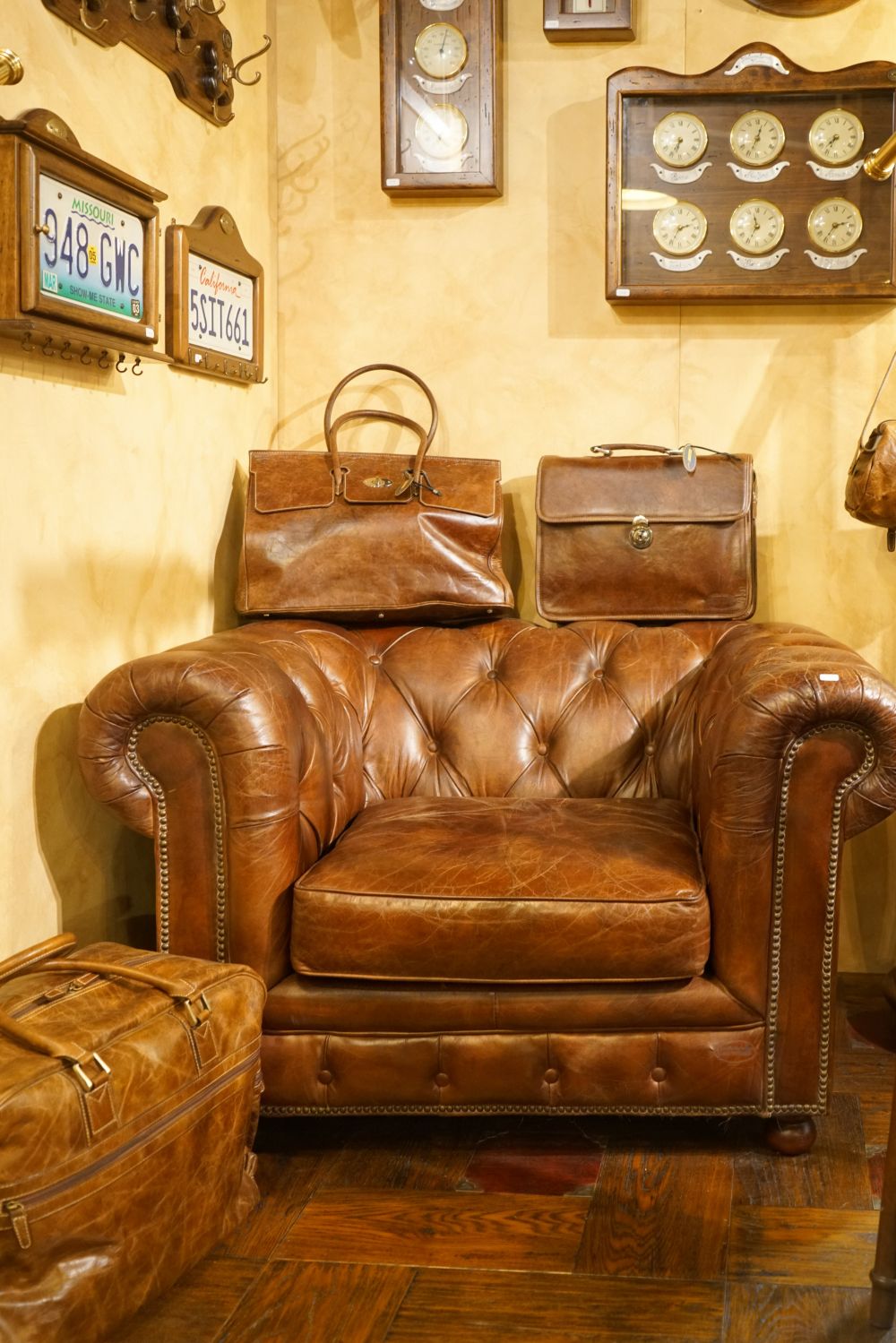 Brown leather armchair with a tufted design men cave reading corner