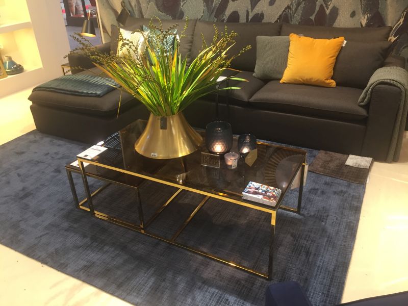 Candles and gold flower vase on the coffee table