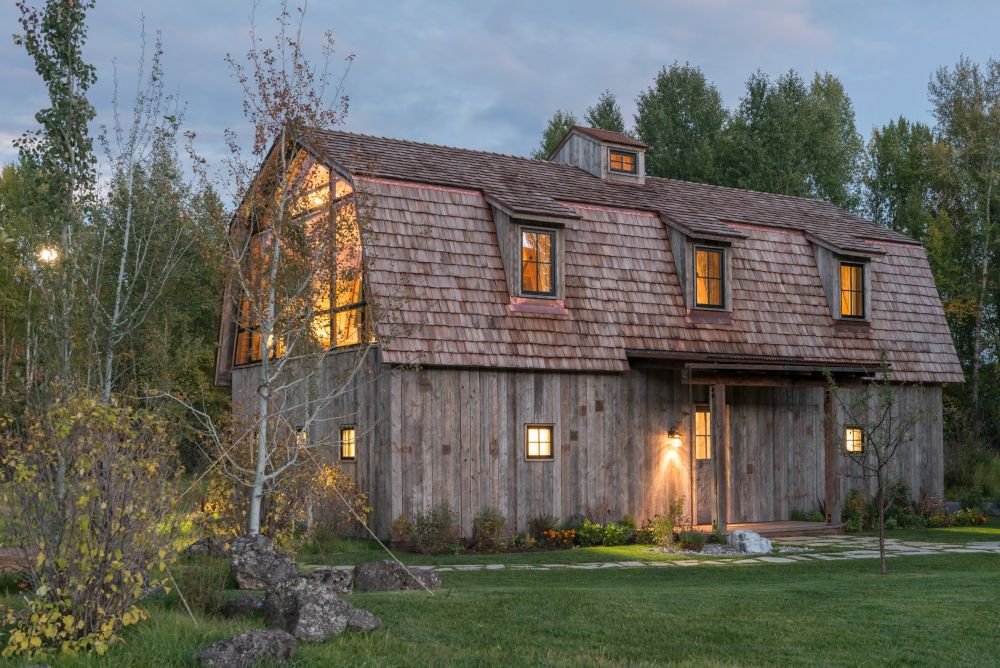 The exterior of the house is covered in reclaimed wood, hence the rustic look