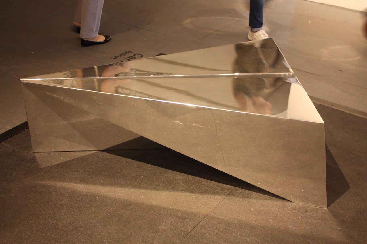 Chekerdjian's IQAR table "blurs the line between origami and metallurgy," says the description. It is made from one sheet of aluminum, and folded by hand.