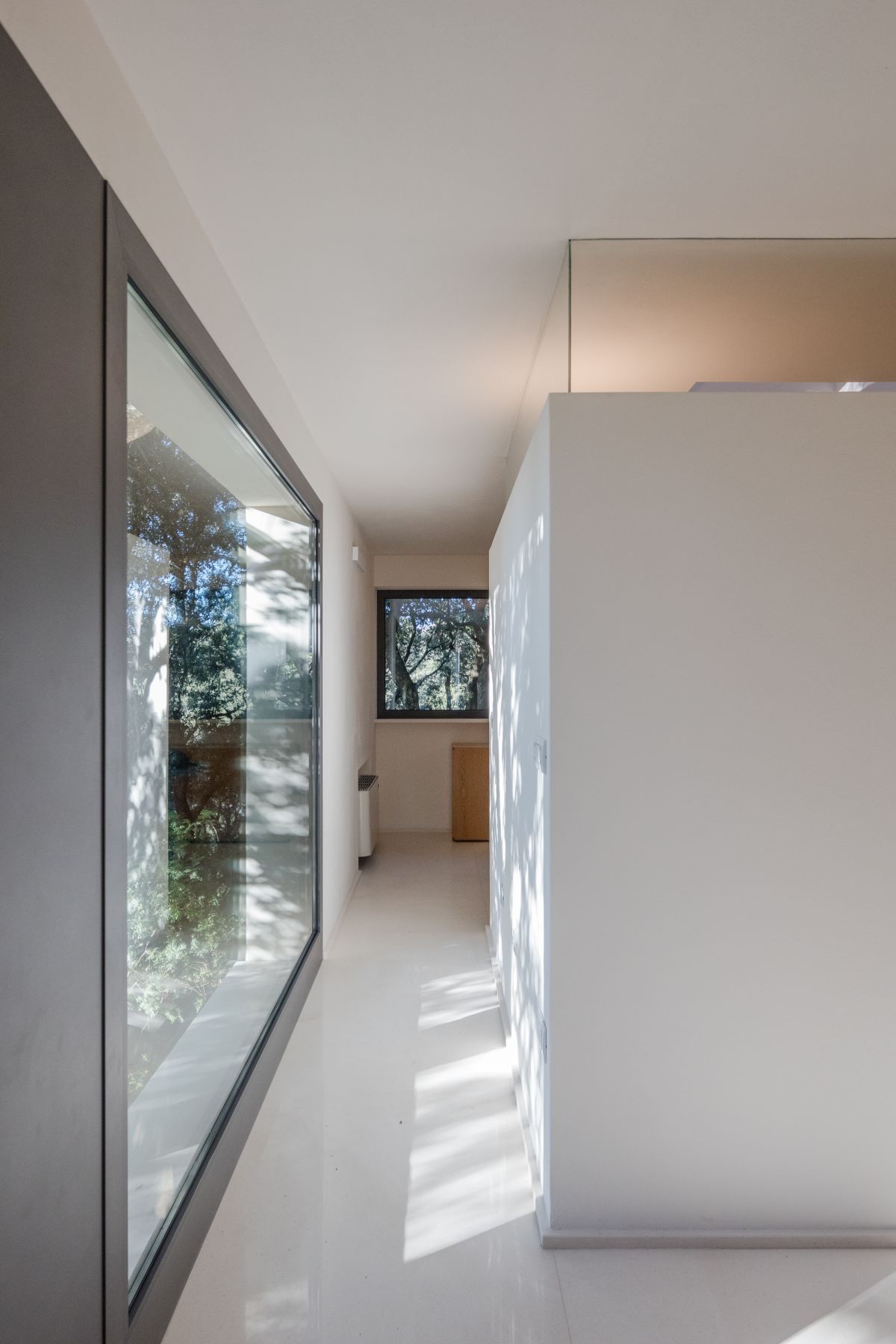 Casa nel Bosco narrow hallway with glass wall