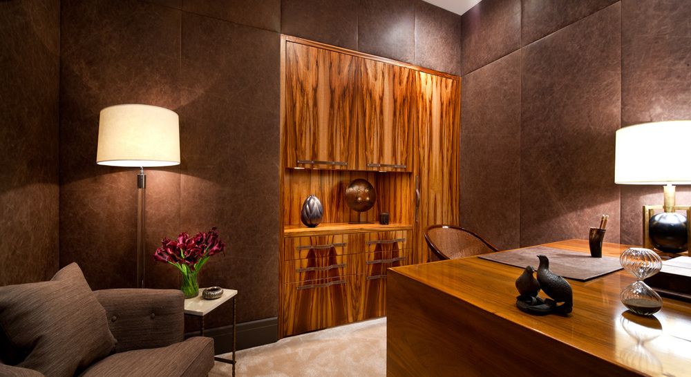 The fascinating grain of the wood cabinetry is the focal point of the home's office. Again the textures of the wood, walls and sofa keep the neutral palette visually engaging.