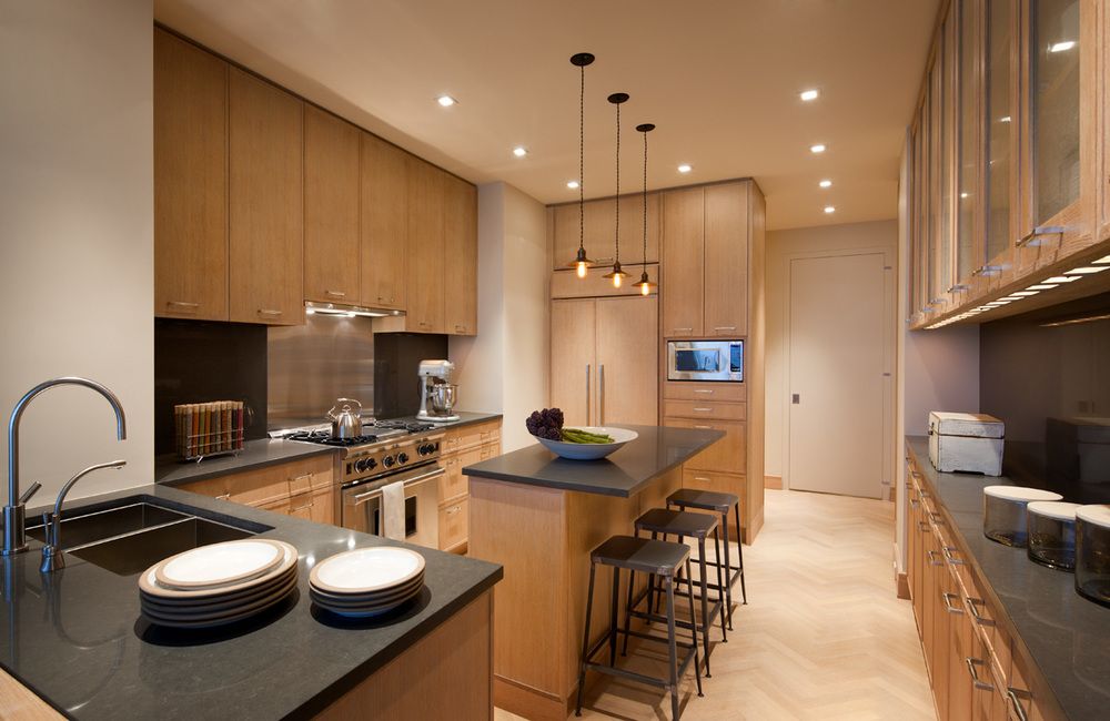 The fully equipped and modern kitchen has every amenity the family needs. The clean lines of the design allow the cabinetry and countertops to shine.