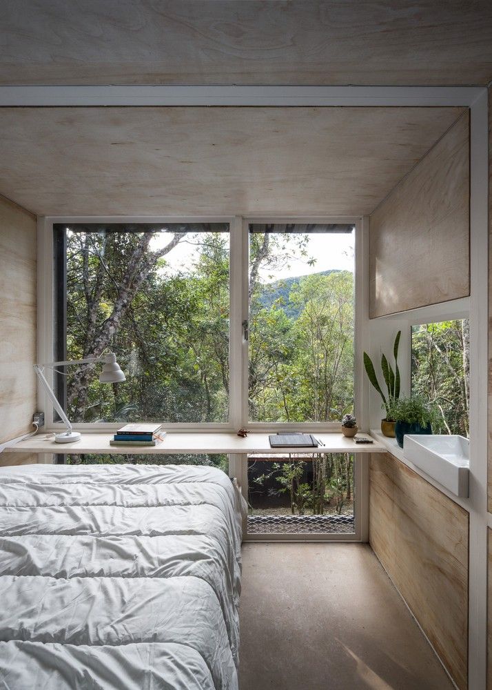 Chalet L plywood interior by Silvia Acar Arquitetura
