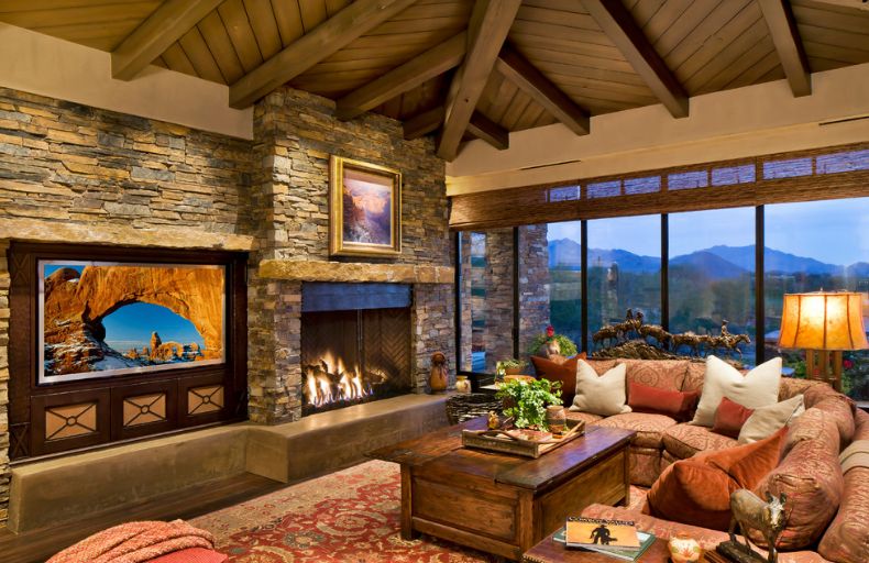 Chalet living room design with a stone stacked fireplace