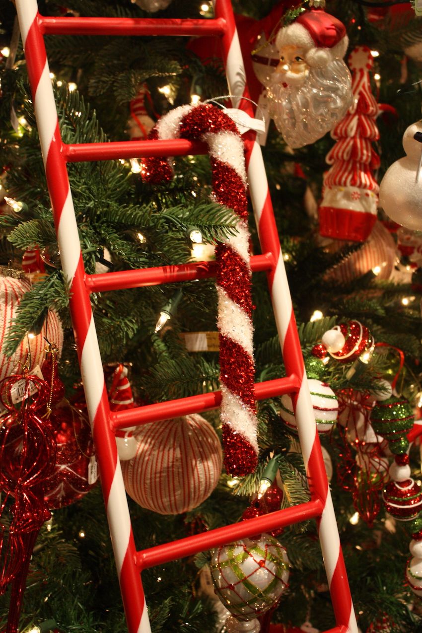 Fluffy, glittery giant candy canes hang on the bright ladders.