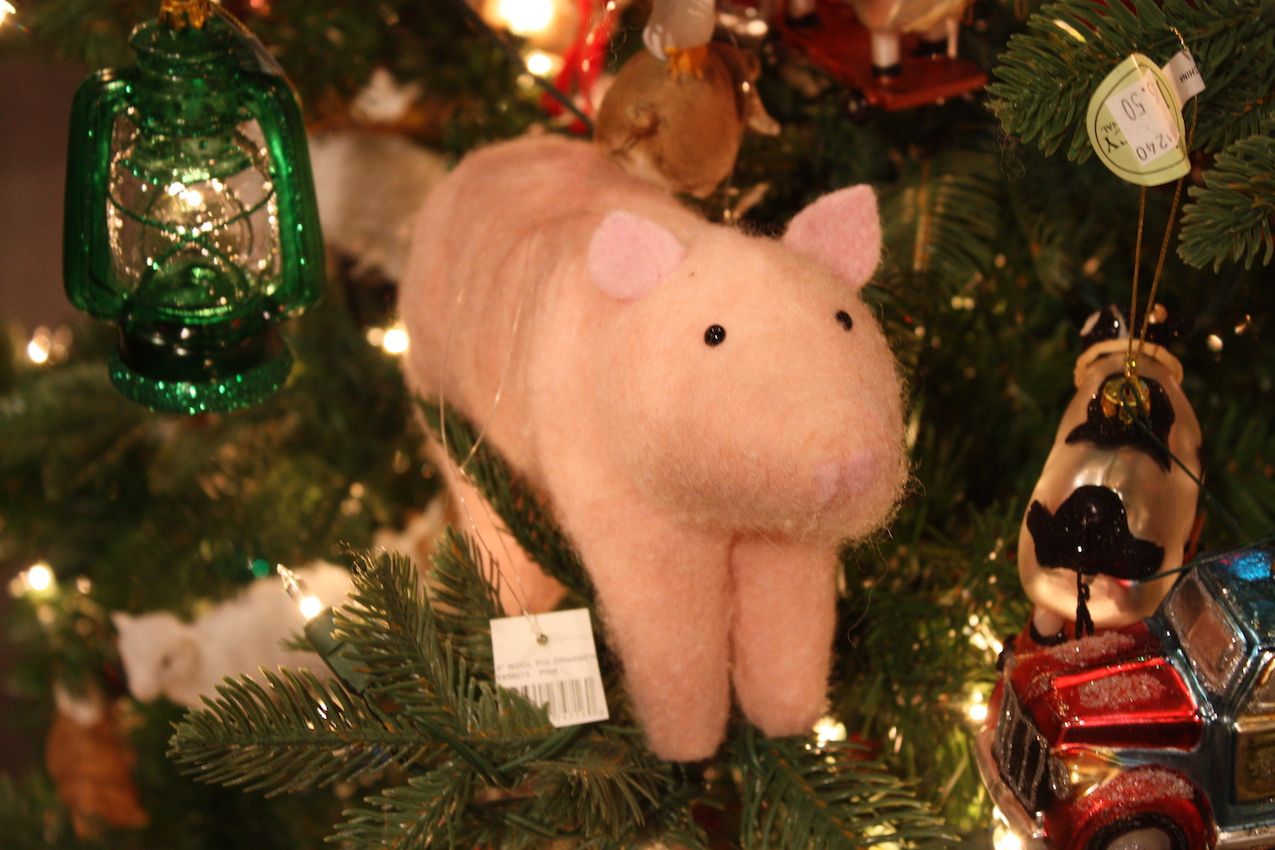 A cute little pink pig is a whimsical addition to the tree's decor.