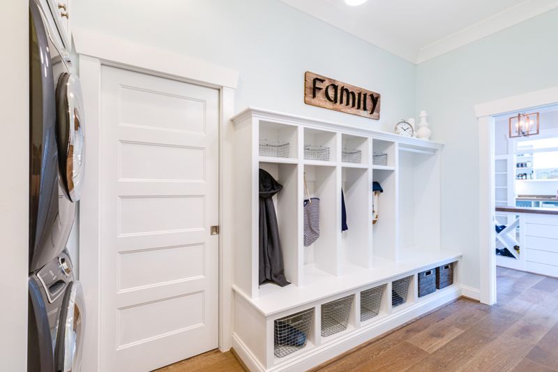 Coastal mudroom decor with stacked waching machine