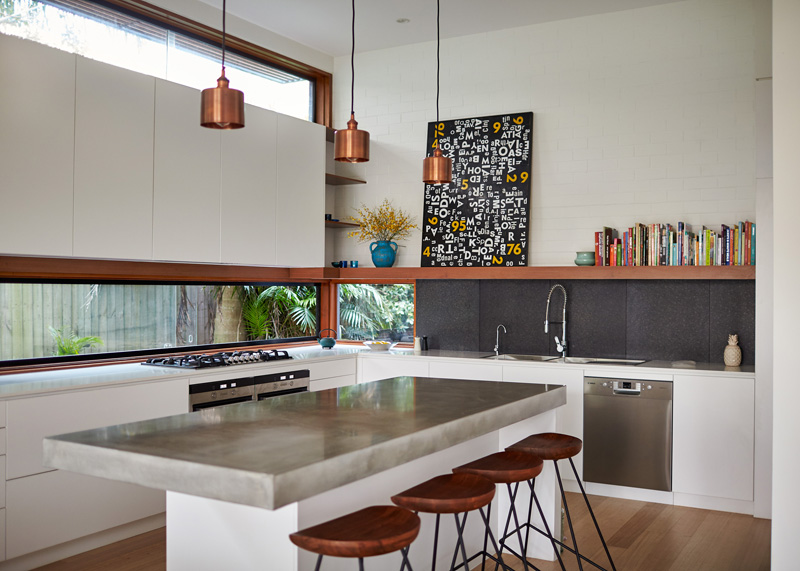 Concrete countertop kitchen island and letterbox window