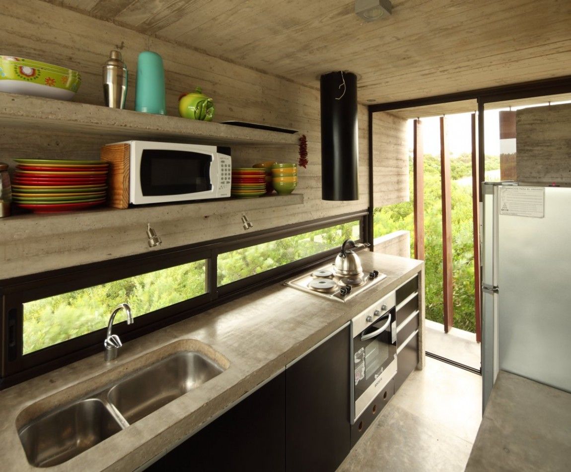 Concrete house kitchen with small windows for backsplash