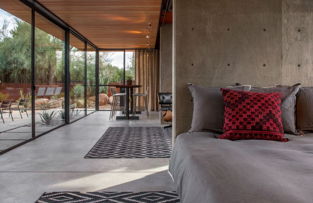 The polished concrete flooring maintains a neutral look throughout, giving the guest house a modern-industrial feel