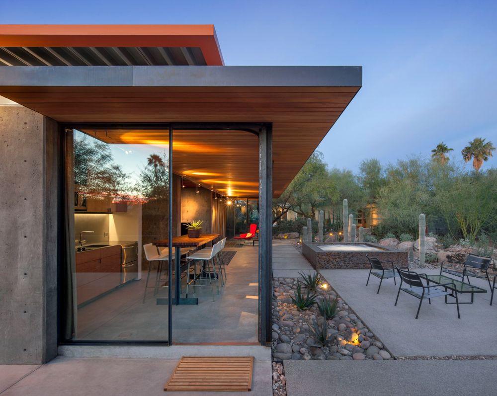 Sliding glass doors ensure a seamless connection between the interior and exterior spaces